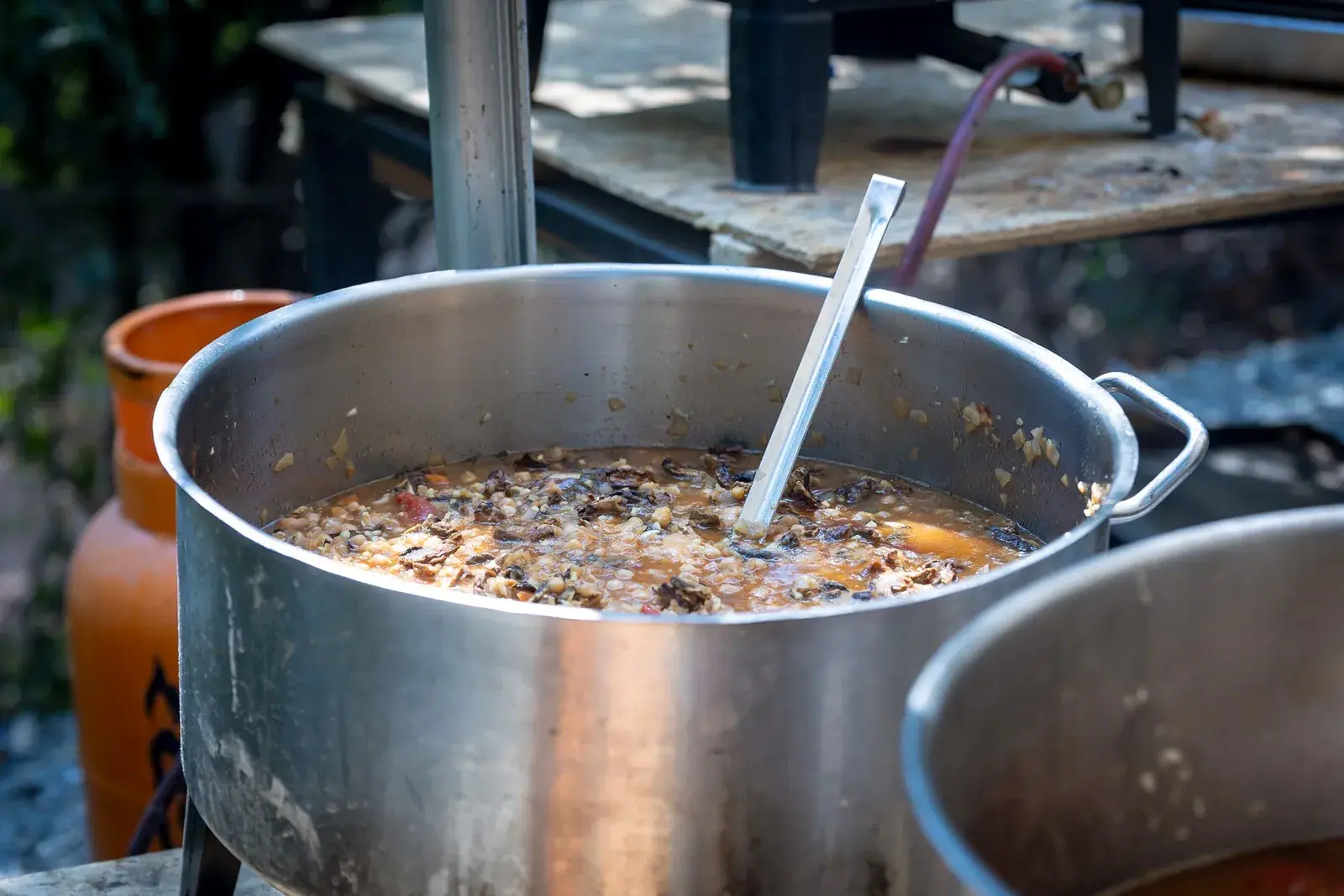 A big pot of food cooking in the village kitchen