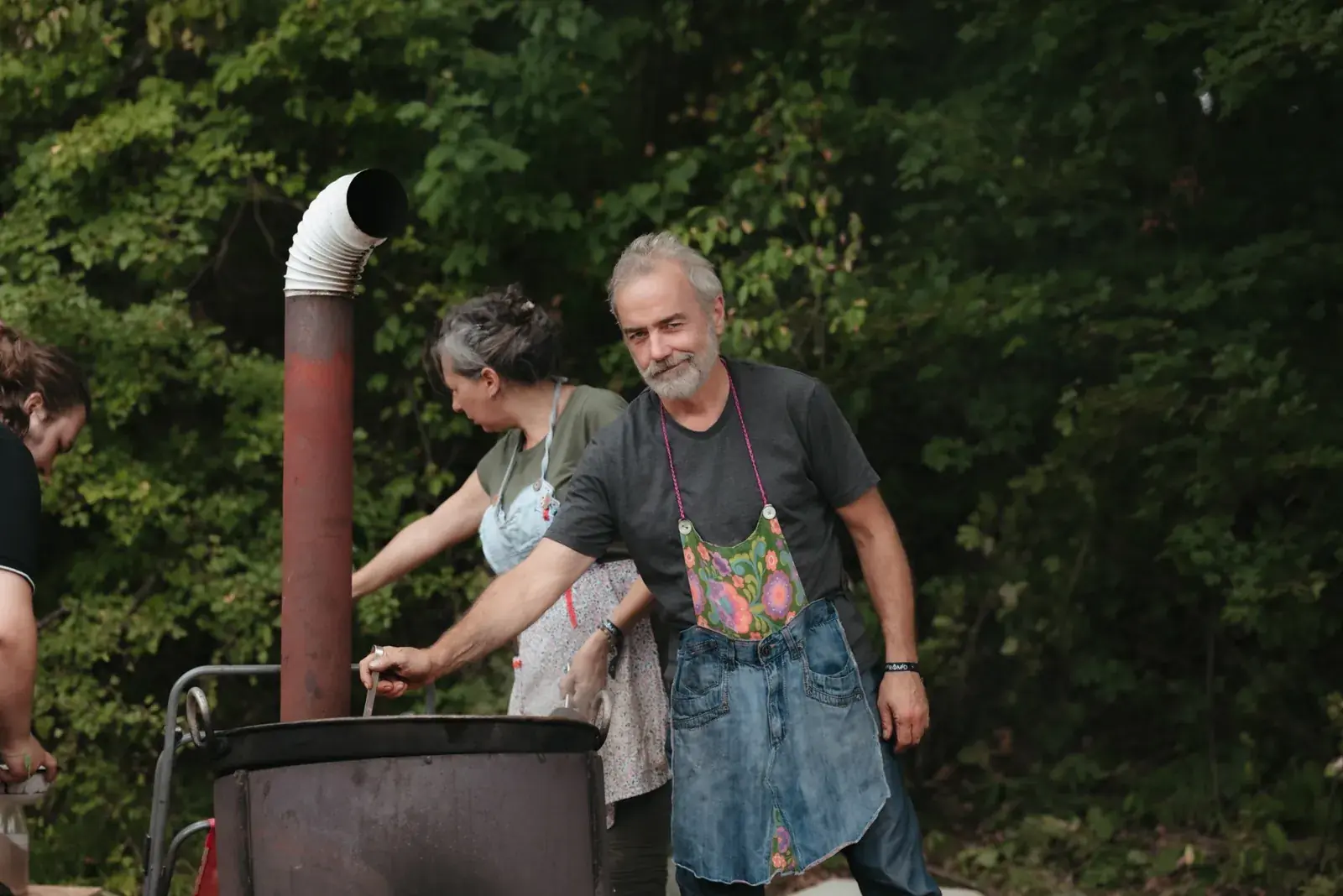 Guests cooking together on the stove in the open-air kitchen