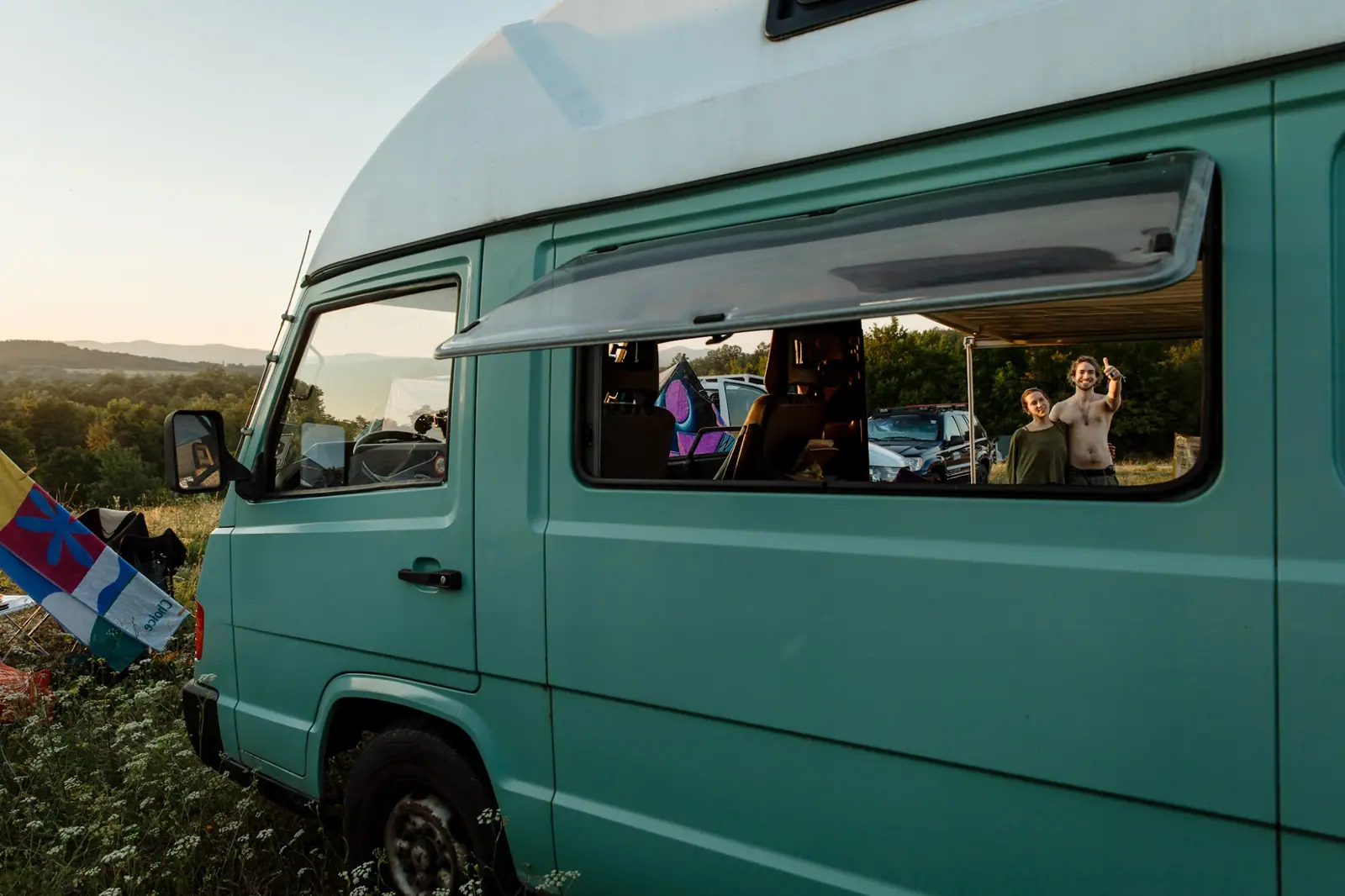 A green campervan on the meadow