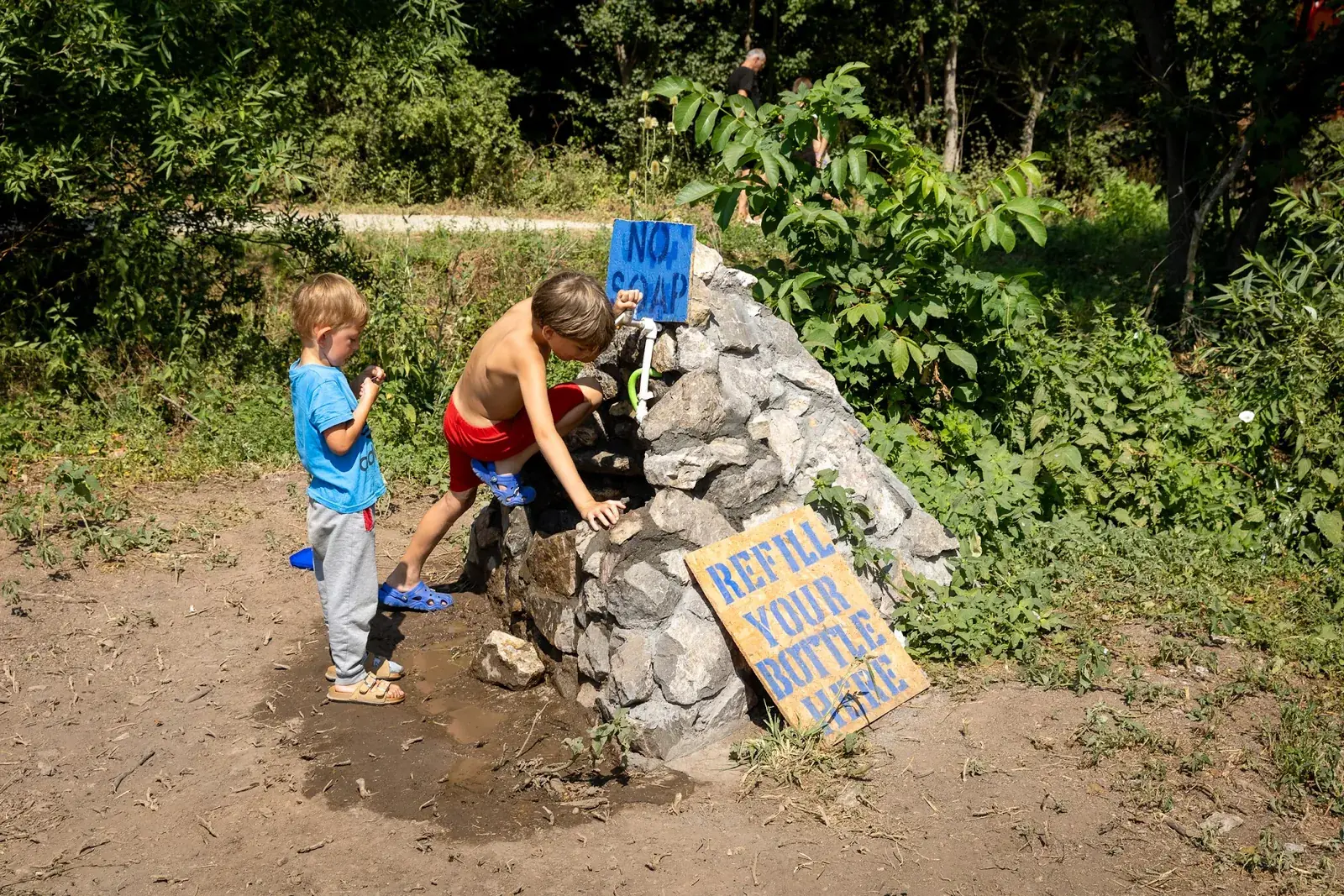 Children refilling bottles at a water station